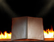 open book in ambient light with fire on background