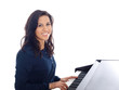 smiling teenage girl playing piano