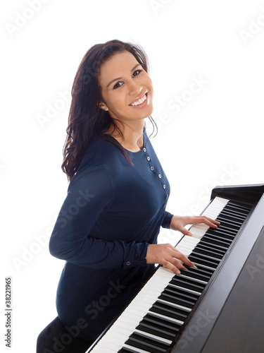 Photo: smiling teenage girl playing piano smiling teenage girl playing piano