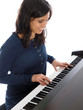 smiling teenage girl playing piano