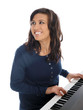 smiling teenage girl playing piano