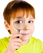 boy looking through a magnifying glass