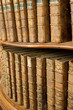 Covers of old medieval literary books on shelves in bookcase