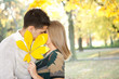 couple kissing behind big leaf