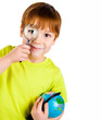 boy looking through a magnifying glass