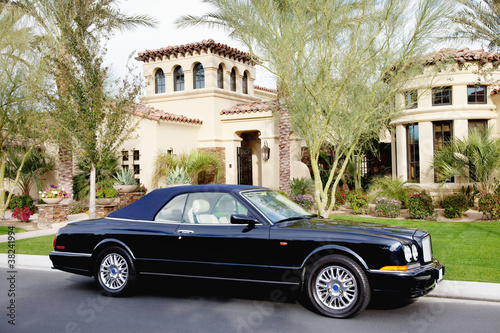 Photo: Luxurious convertible car parked in front of a villa Luxurious convertible car parked in front of a villa