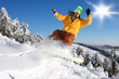 Snowboarder jumping against blue sky