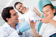 Dentist showing to brush teeth