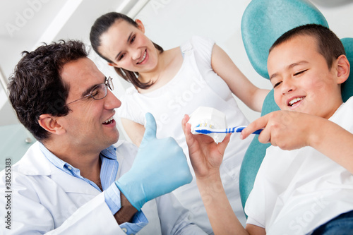 Photo: Dentist showing to brush teeth Dentist showing to brush teeth