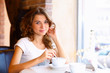 Young pretty woman sitting in restaurant Young pretty woman sitting in restaurant