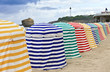 Striped beachtents on sand, facing the ocean, Biarritz, France