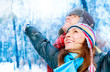 Happy Young Couple In Winter Park Having Fun. Family Outdoors