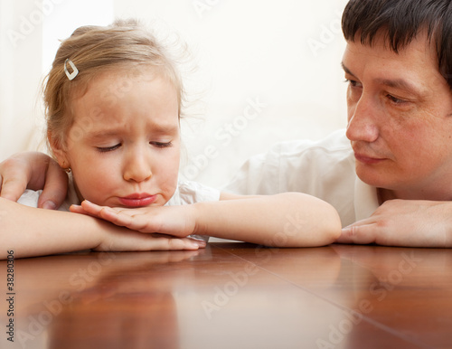 Photo: Father comforts a sad girl Father comforts a sad girl