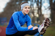 Photo: Young woman stretching before her run. Young woman stretching before her run.