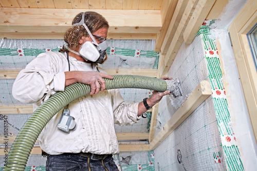 Photo: installing dry cellulose fiber blown-in insulation installing dry cellulose fiber blown-in insulation