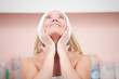Woman applying moisturizer cream