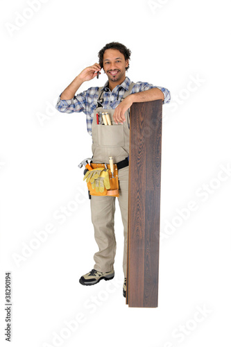 Photo: Man with laminate flooring and cellphone Man with laminate flooring and cellphone