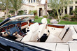 Close-up view of luxury car interior with white leather seats