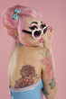 Young woman wearing sunglasses looking over shoulder