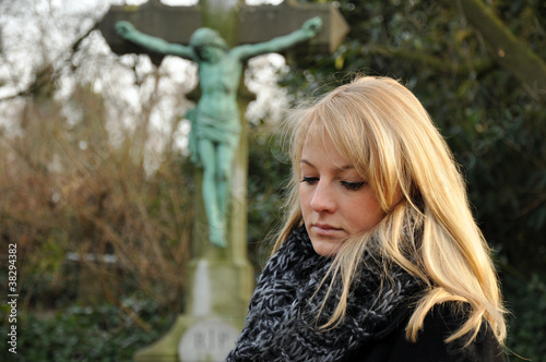 Foto: Frau trauert auf Friedhof Frau trauert auf Friedhof