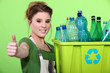 Woman holding crate of plastic bottles