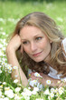 Woman lying in the daisies