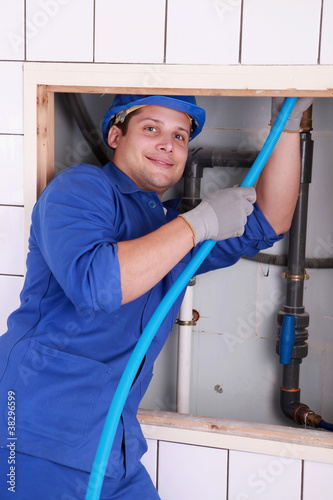 Photo: Plumber fixing some pipes Plumber fixing some pipes