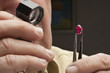 Close up of male jeweler looking at gemstone