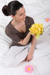 woman sitting cross-legged with water lily