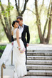 Bride and groom posing outdoors on wedding day