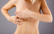 Photo: Woman examining her breast Woman examining her breast