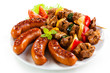 Grilled meat, sausages and vegetables on white background