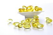 Photo: Cod liver oil pills spilled on white Cod liver oil pills spilled on white