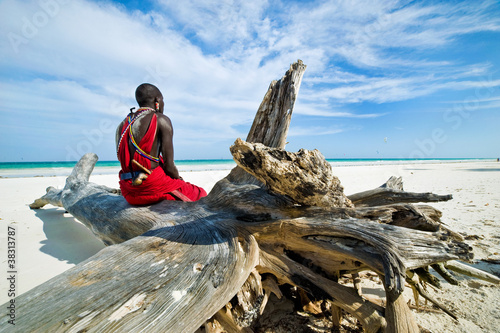Photo: Maasai sitting by the ocean on the beach Maasai sitting by the ocean on the beach