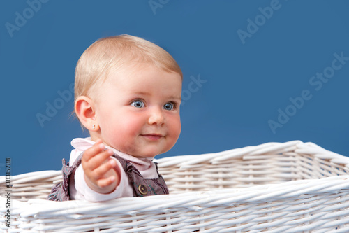 Photo: Portrait of toddler sitting in basket Portrait of toddler sitting in basket