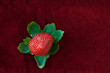 Strawberry from Above with Green Leaves on Red