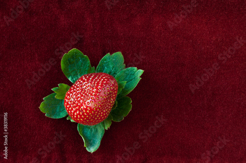 Photo: Strawberry from Above with Green Leaves on Red Strawberry from Above with Green Leaves on Red