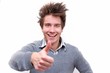 Happy young guy showing thumbs up sign