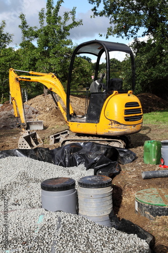 Photo: Mini Digger Installing Sand And Gravel Filter For Sewage Mini Digger Installing Sand And Gravel Filter For Sewage