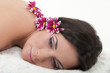 Young beautiful woman with chrysanthemums relaxing on the towel.