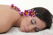 Young beautiful woman with chrysanthemums relaxing on the towel.