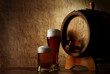 Beer into glass on a old stone and old barrel Beer into glass on a old stone and old barrel