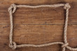 Frame composed of Rope on a Wooden background