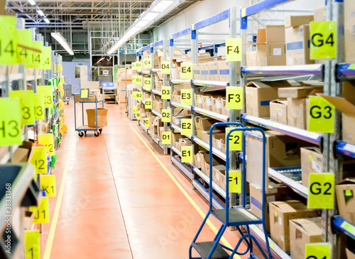 Photo: stands with carton boxes in storage warehouse stands with carton boxes in storage warehouse