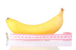 Ripe banana and measuring tape isolated on white