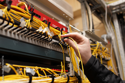 Photo: Technician attaching fiber optic Technician attaching fiber optic