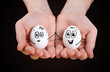 male hand holding funny eggs