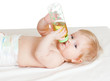 adorable child drinking from bottle. 6 months old girl.