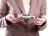 Woman's hands holding the model of car