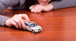Woman's hand holding the model of car